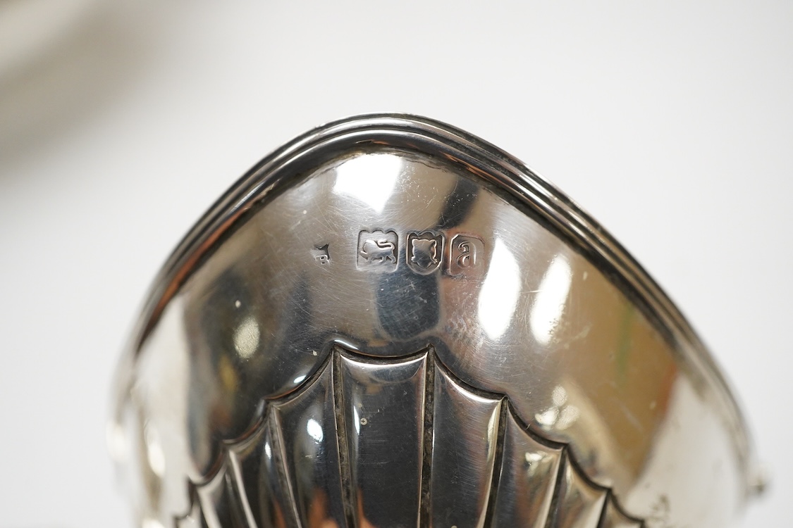 A late Victorian silver boat shaped sugar basket, by Thomas Bradbury & Sons, London, 1896, length 13.2cm, together with a pair of late Victorian repousse silver nut dishes and a silver condiment spoon. 4.8oz.